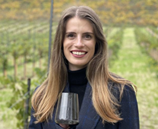 Michaela Kelly standing in vineyard.