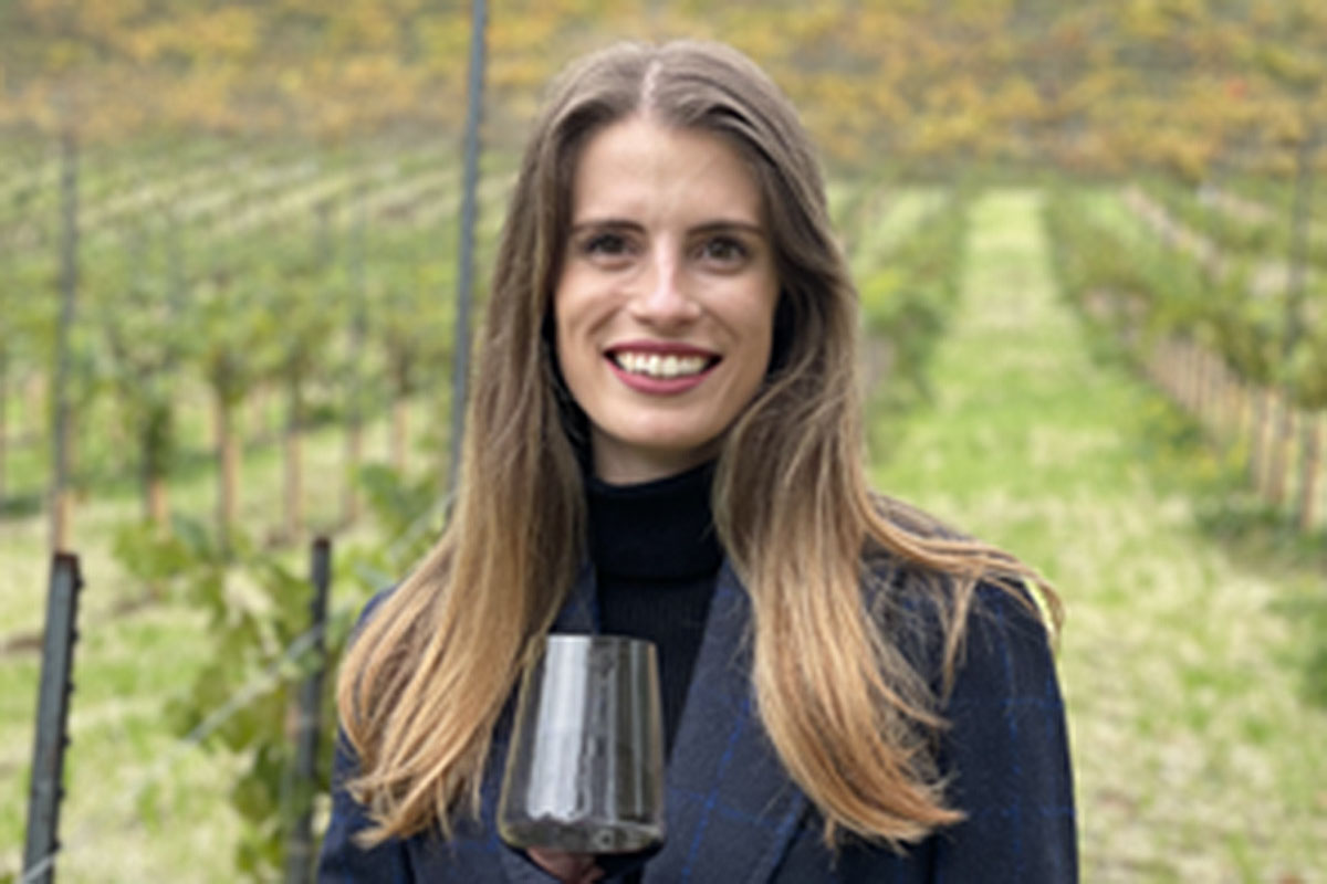 Michaela Kelly standing in vineyard.