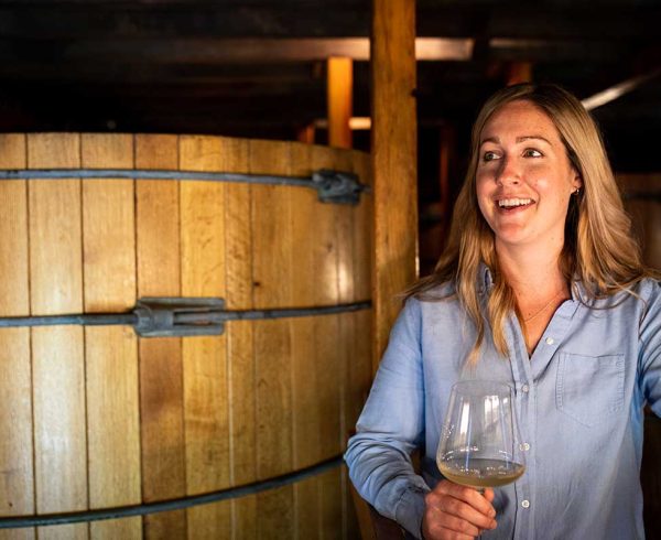 Woman holding wine glass at vineyard