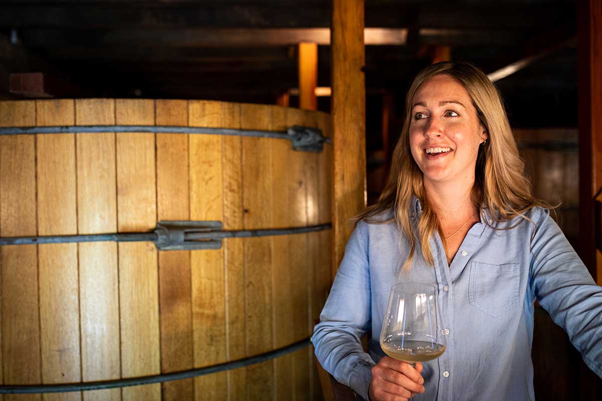 Woman holding wine glass at vineyard