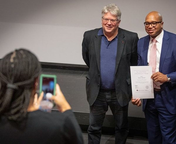 Dean Peter MacKeith, at left, and Ryan Watley get their photo taken during an awards ceremony held on Dec. 9 in Vol Walker Hall. Watley is CEO of Go Forward Pine Bluff, which was a 2021 Dean's Medal recipient.