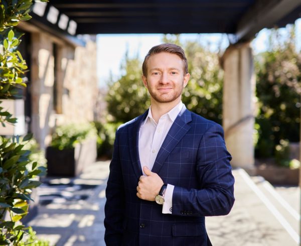 Heitz Cellar master sommelier, Erik Elliott posing outside of vineyard main building.