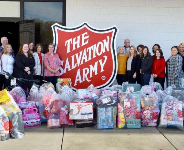 Volunteer State Bank employees standing around The Salvation Army sign.