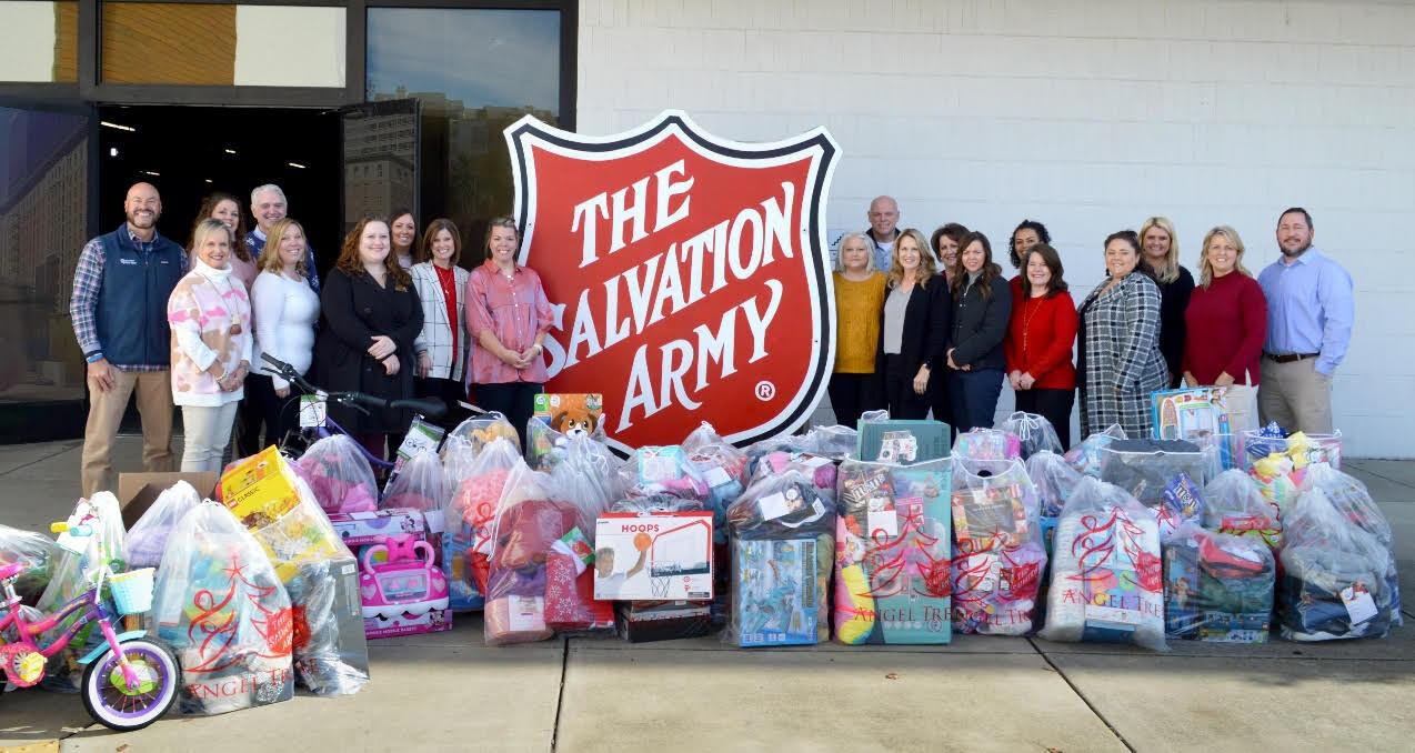 Volunteer State Bank employees standing around The Salvation Army sign.