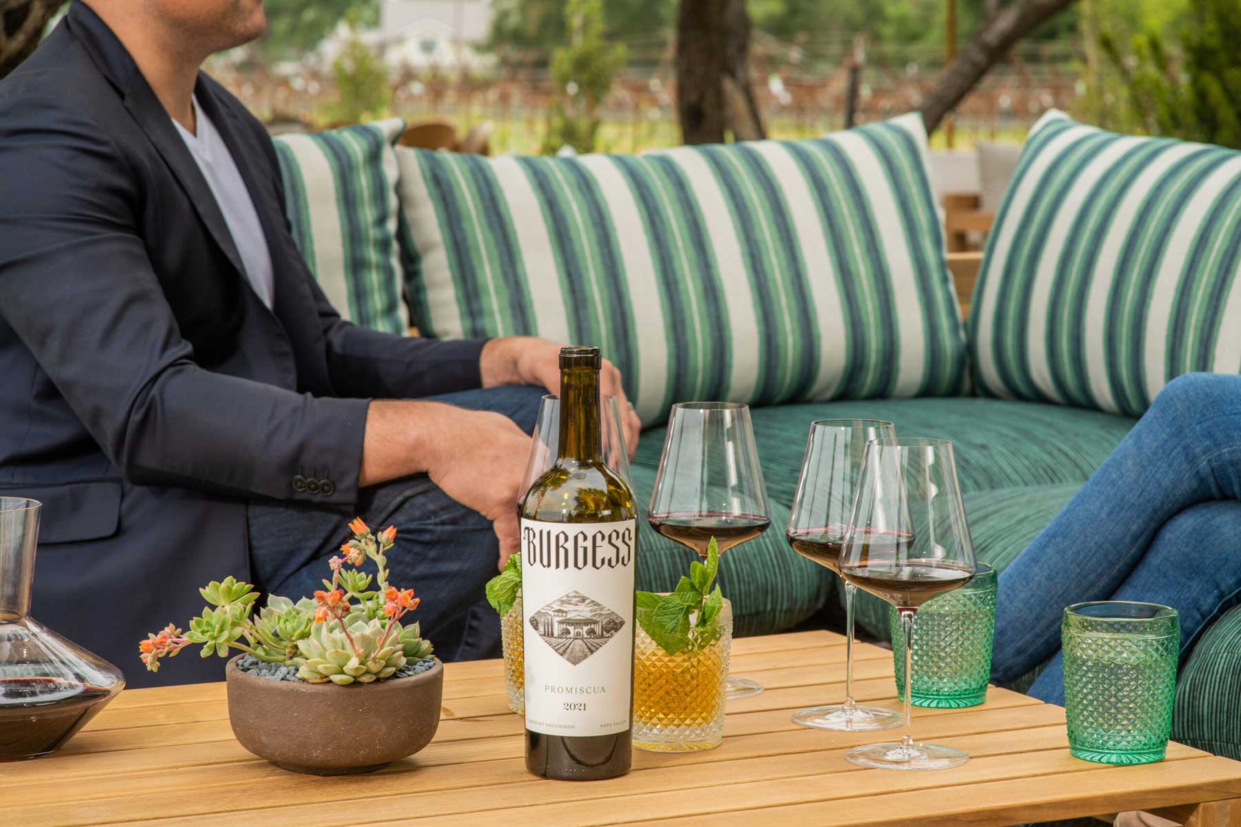 Bottle of Burgess wine on outdoor patio table.