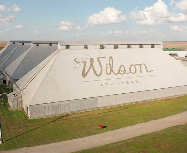 Aerial photo of cotton gin roof that says "Welcome to Wilson, Arkansas"