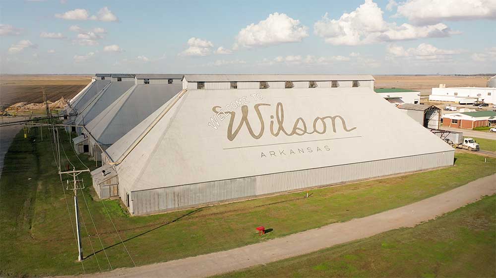 Aerial photo of cotton gin roof that says "Welcome to Wilson, Arkansas"